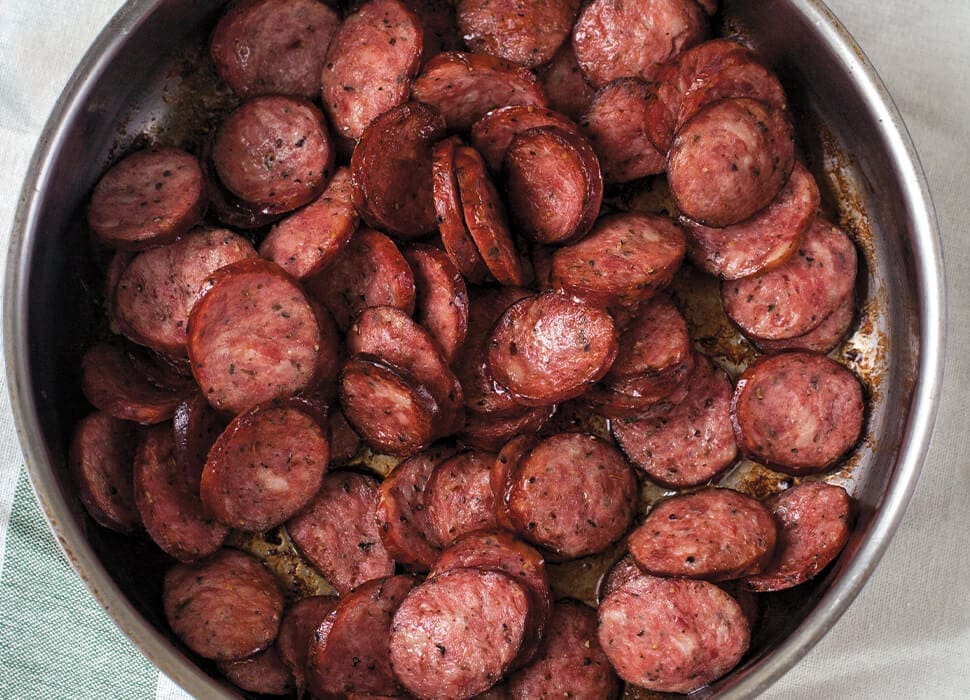 4 Delicious Types of Sausages For The Summer Grilling Season 1 cooked kielbasa slices in a pan